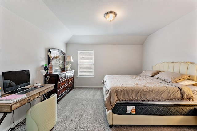 bedroom with baseboards, light colored carpet, and vaulted ceiling
