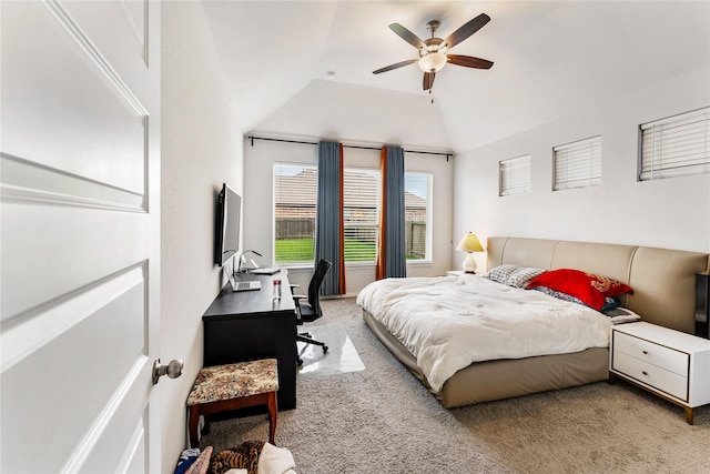 carpeted bedroom featuring ceiling fan and vaulted ceiling