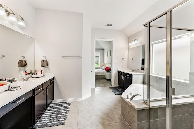 ensuite bathroom with visible vents, a bath, a stall shower, and a sink