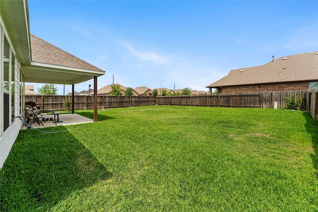 view of yard featuring a patio area and a fenced backyard