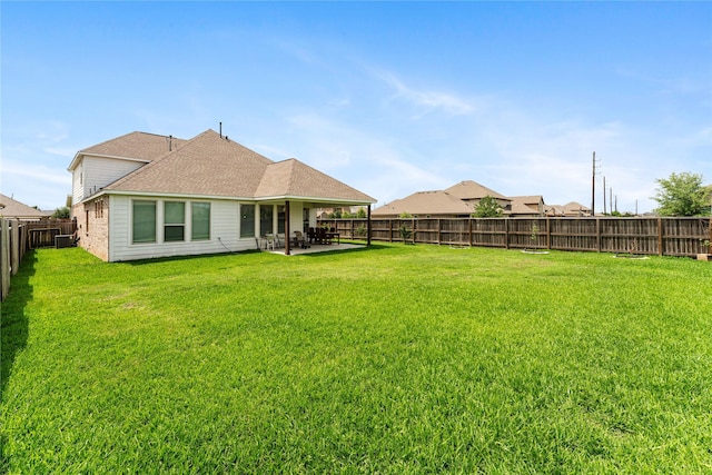 view of yard featuring central AC, a fenced backyard, and a patio area