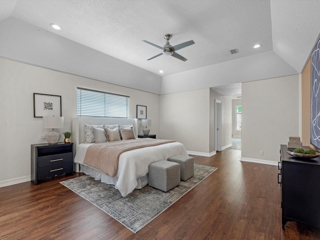 bedroom featuring visible vents, a textured ceiling, dark wood finished floors, and lofted ceiling