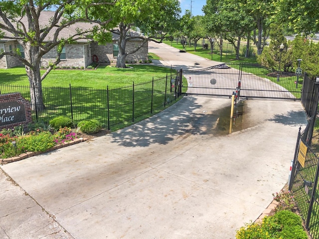 surrounding community with a gate, fence, and a yard
