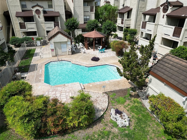 pool with fence, a gazebo, and a patio area