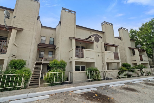 view of building exterior featuring uncovered parking