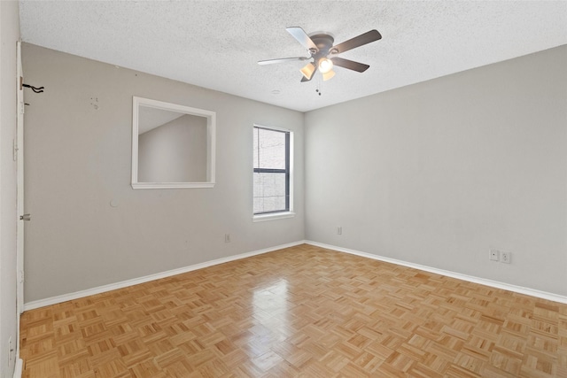 empty room featuring baseboards, ceiling fan, and a textured ceiling