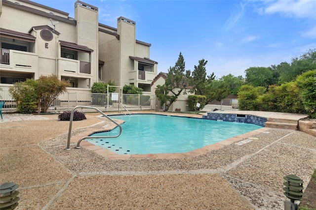 pool with fence and a patio area