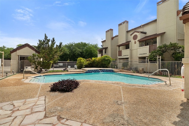 community pool featuring a patio and fence