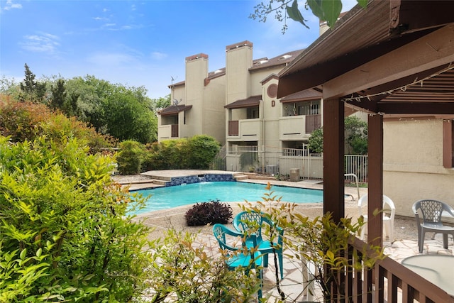 pool with a patio and fence
