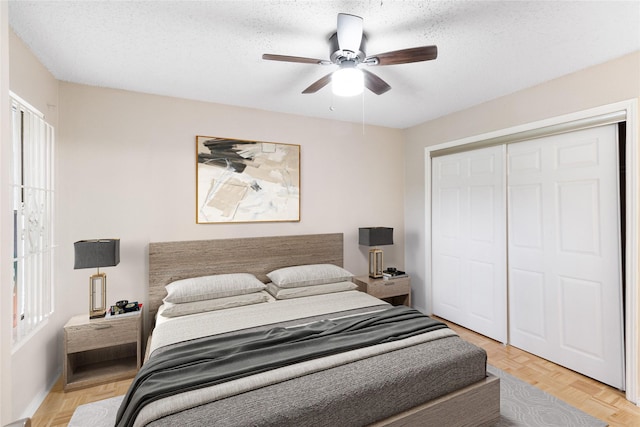 5322 Medical Dr Unit E203, San Antonio, TX 78240 - bedroom featuring a closet, a ceiling fan, and a textured ceiling