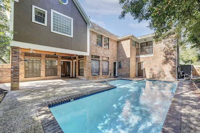 5102 Danebridge Dr, Houston, TX 77084 - back of house featuring an outdoor pool, brick siding, a patio, and french doors
