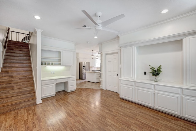 interior space featuring light wood finished floors, recessed lighting, stairway, a ceiling fan, and ornamental molding