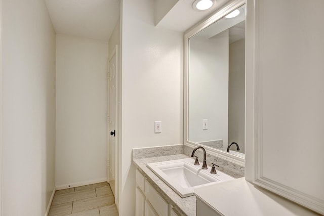 bathroom with tile patterned floors, vanity, and baseboards