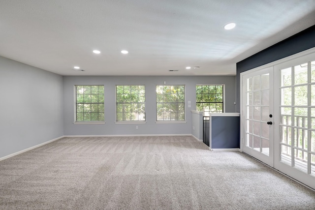 interior space featuring french doors, baseboards, and light carpet