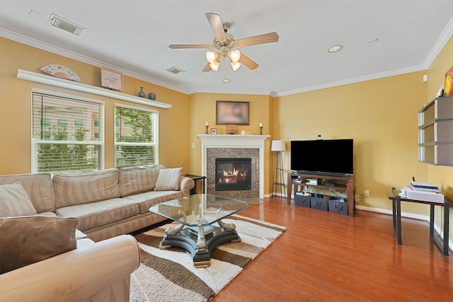 6107 S Arrowana Ln, Houston, TX 77036 - living area featuring crown molding, ceiling fan, wood finished floors, a fireplace with flush hearth, and recessed lighting