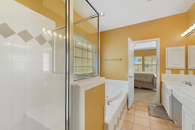 ensuite bathroom featuring vanity, tile patterned floors, connected bathroom, and a stall shower
