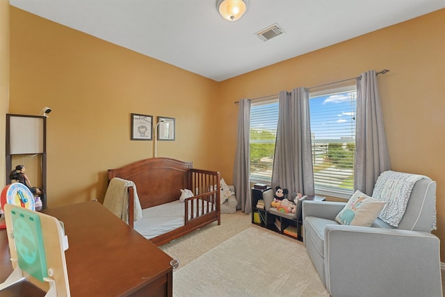 6107 S Arrowana Ln, Houston, TX 77036 - bedroom featuring carpet flooring and a crib