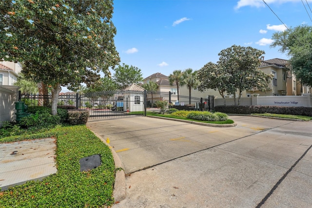 6107 S Arrowana Ln, Houston, TX 77036 - view of concrete street featuring a gate, a gated entry, and curbs