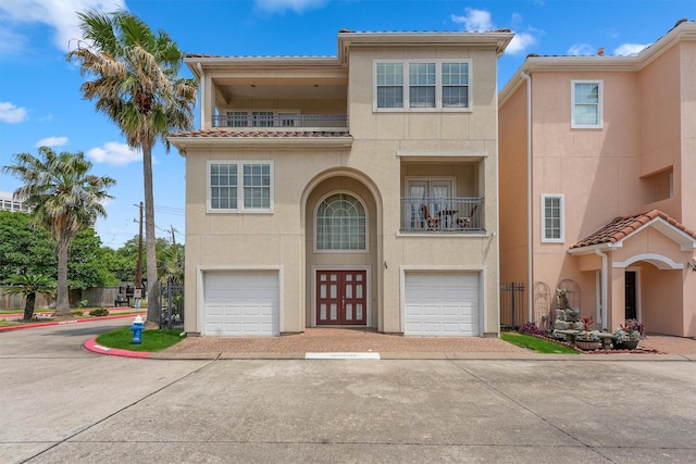 6107 S Arrowana Ln, Houston, TX 77036 - view of front of property with stucco siding, a balcony, a garage, and a tiled roof