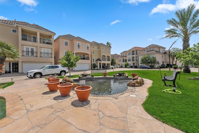 view of home's community featuring a residential view, an attached garage, and a lawn