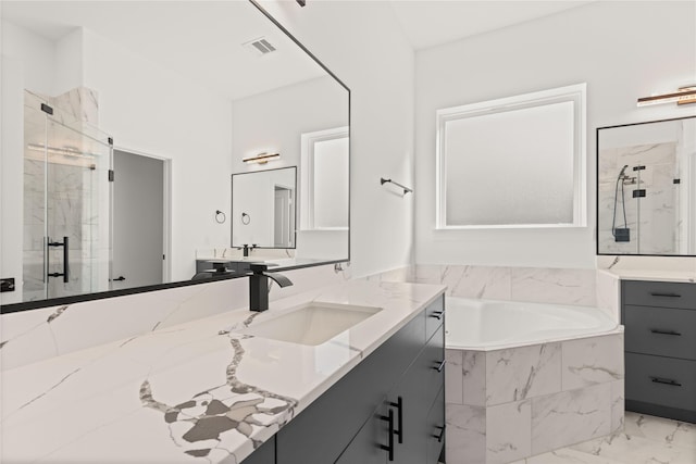 2707 Dennis St, Houston, TX 77004 - full bathroom with visible vents, a marble finish shower, a garden tub, and marble finish floor