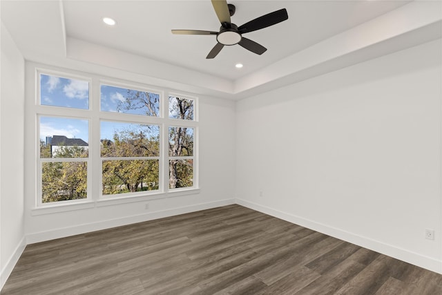 2707 Dennis St, Houston, TX 77004 - empty room featuring baseboards, dark wood-style floors, and a tray ceiling