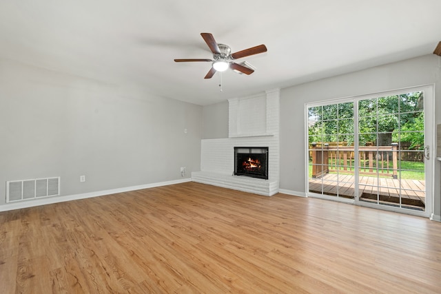 unfurnished living room with a ceiling fan, visible vents, light wood-style flooring, and baseboards