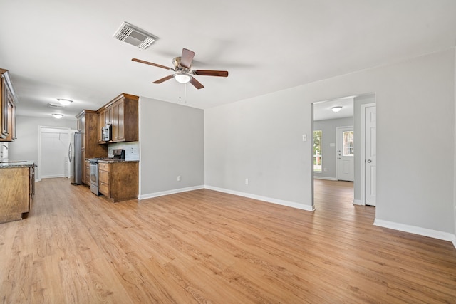 unfurnished living room featuring baseboards, visible vents, ceiling fan, and light wood-style floors