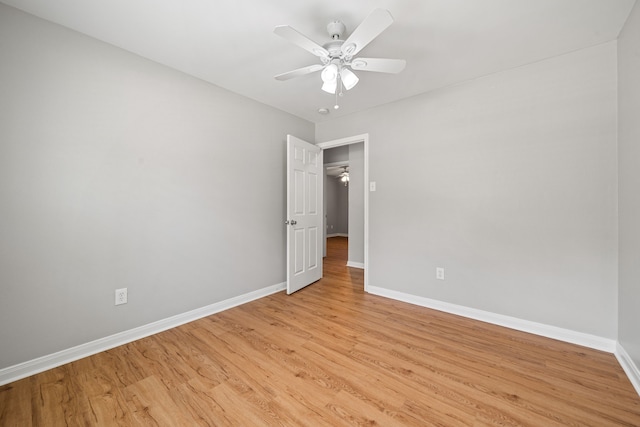 unfurnished bedroom featuring light wood-style floors, ceiling fan, and baseboards