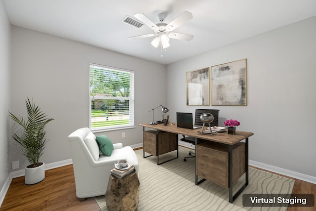 office space with baseboards, visible vents, wood finished floors, and ceiling fan