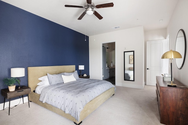 bedroom featuring ensuite bath, carpet, ceiling fan, baseboards, and visible vents
