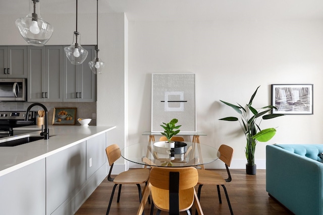 dining room featuring baseboards and dark wood-style flooring