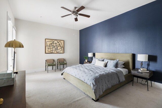 carpeted bedroom featuring a ceiling fan and baseboards
