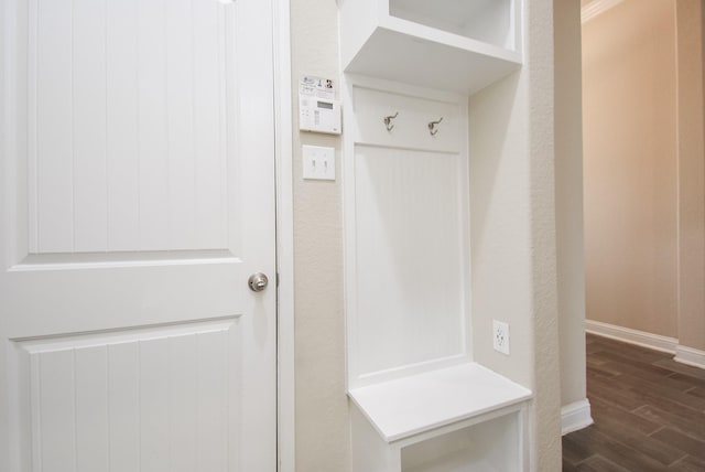 mudroom featuring baseboards and dark wood finished floors