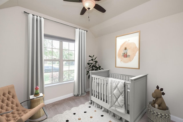bedroom with a nursery area, baseboards, vaulted ceiling, and multiple windows