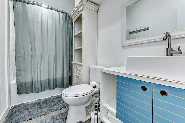 bathroom featuring toilet, shower / bathtub combination with curtain, and vanity