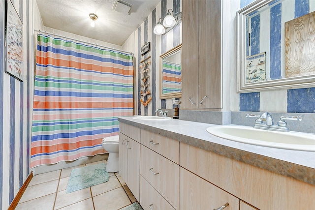 bathroom featuring toilet, a sink, tile patterned floors, and visible vents