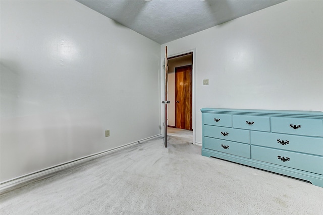 unfurnished bedroom featuring baseboards and carpet