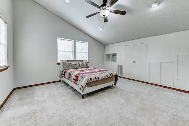 carpeted bedroom with baseboards, visible vents, ceiling fan, and lofted ceiling