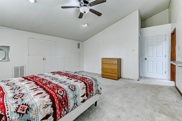 bedroom featuring lofted ceiling, visible vents, and light carpet