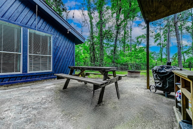view of patio / terrace featuring a grill and fence