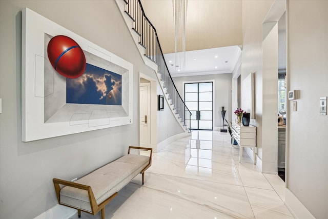3851 Chevy Chase Dr, Houston, TX 77019 - hallway featuring ornamental molding, a high ceiling, stairway, and baseboards