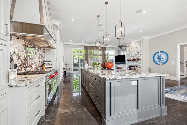 3851 Chevy Chase Dr, Houston, TX 77019 - kitchen with range with two ovens, wall chimney exhaust hood, crown molding, and marble finish floor