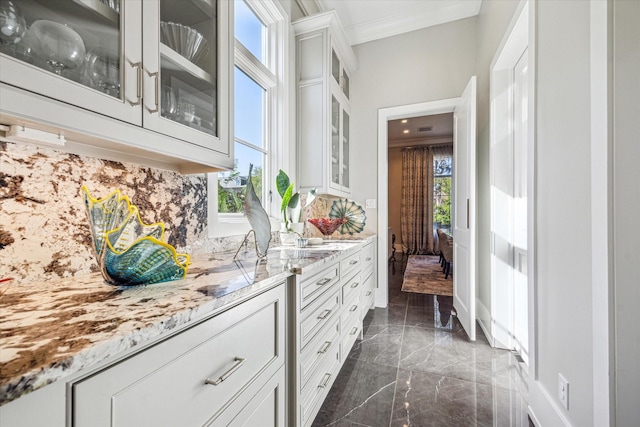 3851 Chevy Chase Dr, Houston, TX 77019 - interior space featuring decorative backsplash, a wealth of natural light, crown molding, and marble finish floor