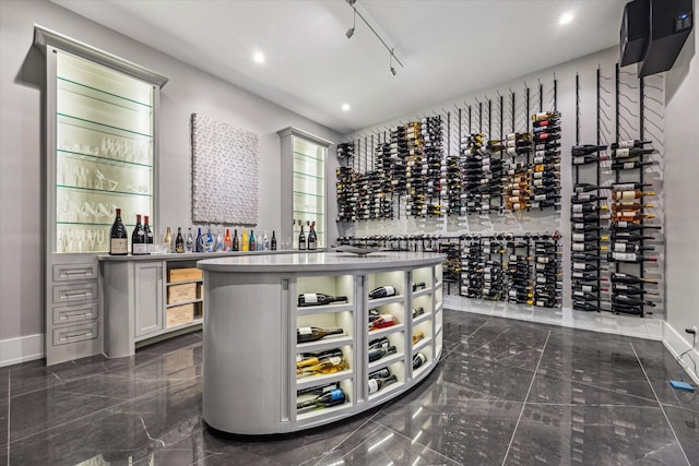 3851 Chevy Chase Dr, Houston, TX 77019 - wine cellar featuring recessed lighting, marble finish floor, a bar, and baseboards
