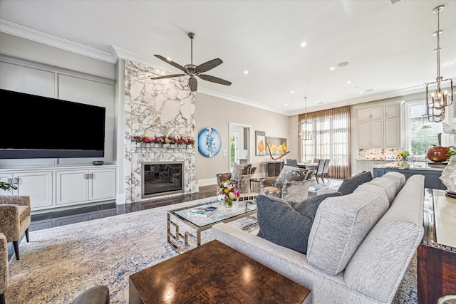 3851 Chevy Chase Dr, Houston, TX 77019 - living room with recessed lighting, ceiling fan with notable chandelier, a fireplace, and crown molding