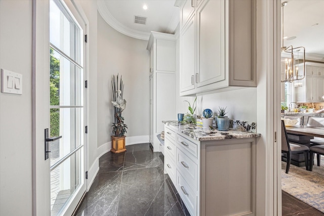 3851 Chevy Chase Dr, Houston, TX 77019 - interior space featuring a notable chandelier, marble finish floor, visible vents, baseboards, and ornamental molding
