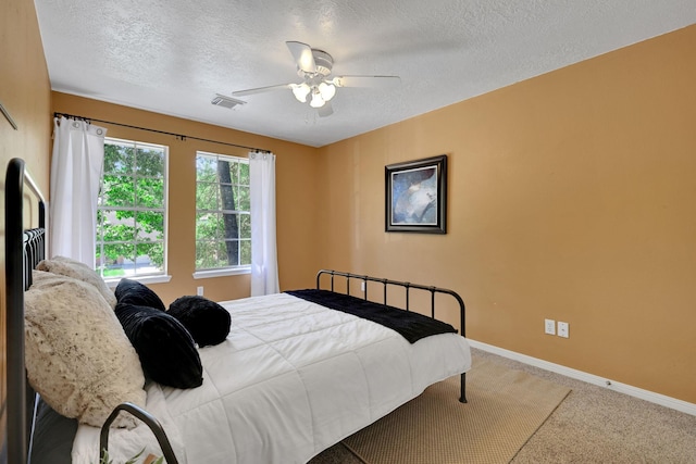 3739 Apple Hollow Ln, Humble, TX 77396 - carpeted bedroom featuring a textured ceiling, baseboards, and a ceiling fan