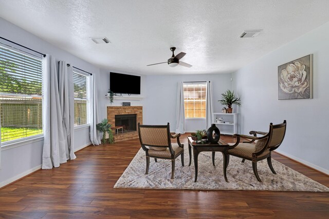 3739 Apple Hollow Ln, Humble, TX 77396 - dining area with ceiling fan, a fireplace, wood finished floors, a textured ceiling, and baseboards