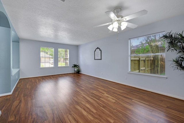 3739 Apple Hollow Ln, Humble, TX 77396 - empty room with a ceiling fan, wood finished floors, a textured ceiling, and baseboards